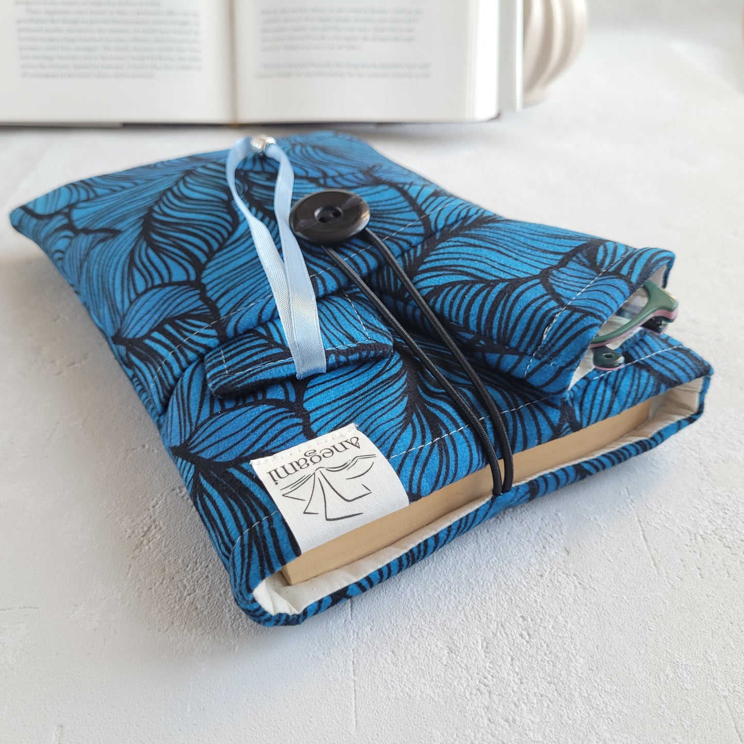 Elegante set regalo libresco, custodia imbottita per libri con tasca e segnalibro in tessuto con nappa